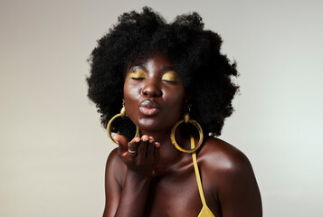 Black woman, beauty and retro fashion, afro hair and blow air kiss with gold makeup and jewelry on...