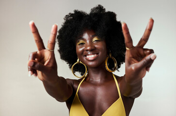 Black woman, peace sign and fashion afro hairstyle on studio background with style, trend and makeup cosmetics. Portrait, fun or happy beauty model with playful and good energy hands gesture in Congo