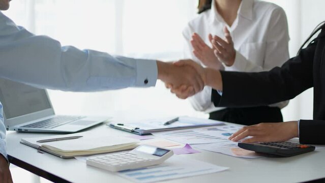 Business people shaking hands to congratulate success. Business team meeting and presenting business results discussion and analysis data chart and graph, finance and accounting