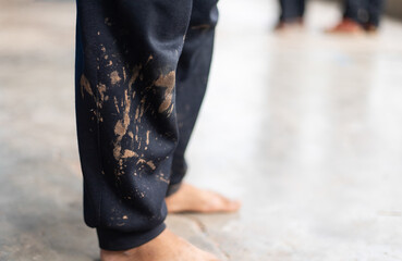 dirty mud stain on kid pants from long playing in daily life activity. dirty stain for cleaning...