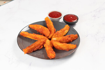 Potatos wedges with tomato sauce served in dish isolated on background side view of fastfood
