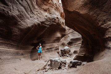 Young woman hiking on a rock canyon