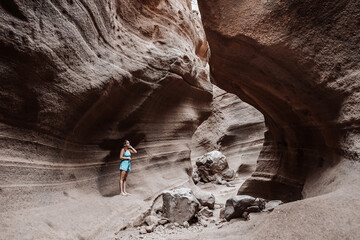 Young woman hiking on a rock canyon