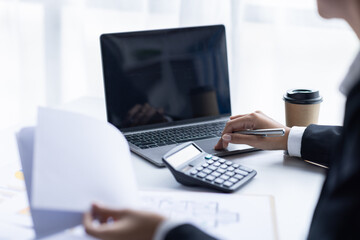 Asian female accountant or banker making calculations. Young business asian woman in workplace,...