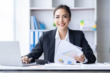 Asian female accountant or banker making calculations. Young business asian woman in workplace, Documents, tax, report for analysis Savings, finances and economy concept.