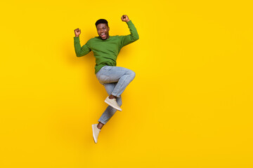 Fototapeta na wymiar Full length body size view of attractive cheery guy jumping rejoicing attainment isolated over bright yellow color background