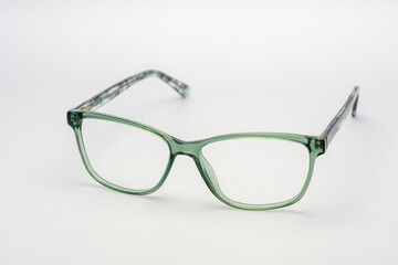 Eyeglass frames, lenses, various colors, both metal and plastic, on a beautiful colored background.