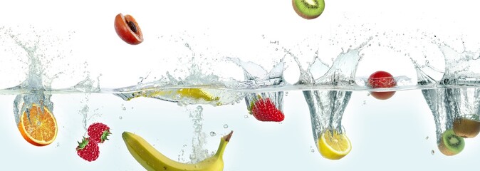 Various fruits splashing in water.