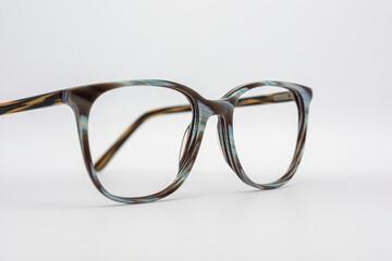 Eyeglass frames, lenses, various colors, both metal and plastic, on a beautiful colored background.