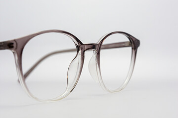 Eyeglass frames, lenses, various colors, both metal and plastic, on a beautiful colored background.