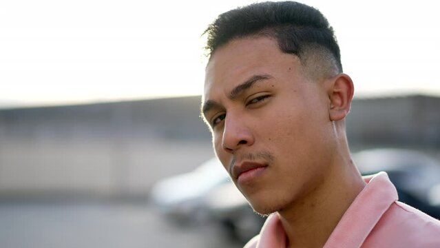 One serious hispanic man looking at camera with skeptical emotion. Portrait male Brazilian person