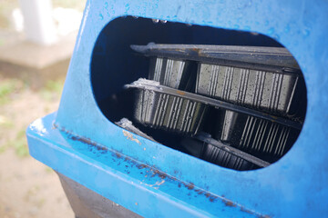 Bag with garbage and rubbish bin