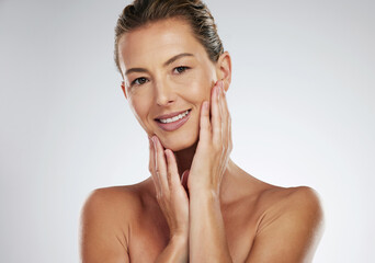 Face wellness, skincare and mature woman with smile for dermatology against a grey mockup studio...