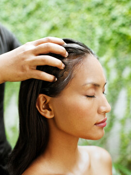 Woman receiving scalp massage at a Spa,  Bali, Indonesia.