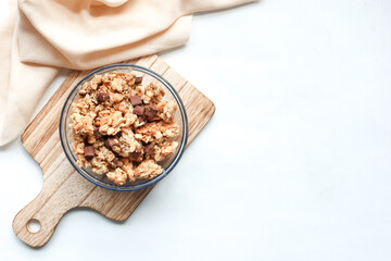 chocolate Musli in a bowl on white background with copy space 