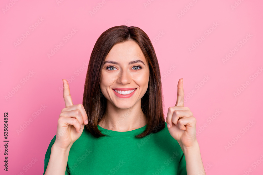 Poster closeup photo of young attractive pretty girl directing fingers up smiling information isolated on p