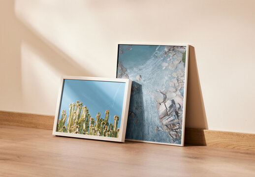 Group of Two Picture Frames Lean on a Wall