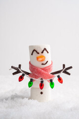 Happy funny marshmallow snowman are having fun in snow. Merry Christmas card. Christmas concept