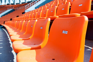 Empty orange seat in stadium