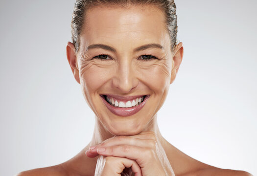 Skincare, anti aging and beautiful mature woman with a smile on her face on white background. Beauty, botox and collagen, a middle aged lady from USA with health, wellness and wrinkles on clean skin