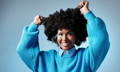 Happy, black woman and healthy natural hair with afro against blue studio mockup background. Young...