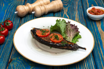 Homemade baked eggplant served with cherry tomatoes, pepper and chili sauce
