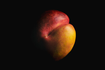 A ripe nectarine close-up on a black background.