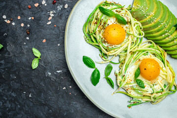 keto breakfast zucchini with eggs and avocado. Vegetarian vegetable pasta, Food recipe background. Close up