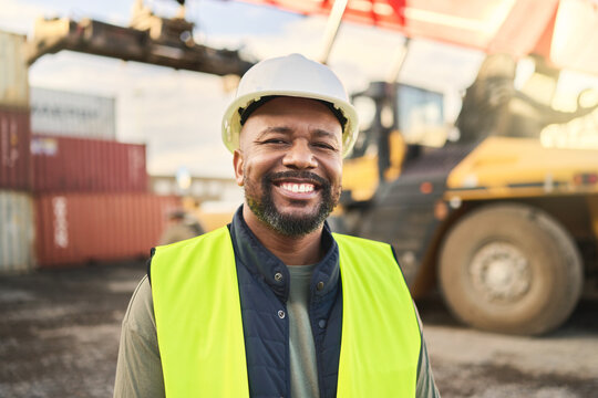 Portrait, Smile And Work In Logistics With Container At Export And Distribution Shipyard. Black Man, Happy And Confident Has Motivation Working In Shipping, Cargo And Supply Chain Industry At Port