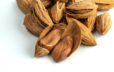 Bunch of Inshell almonds. Isolated on a white background. Selective focus.