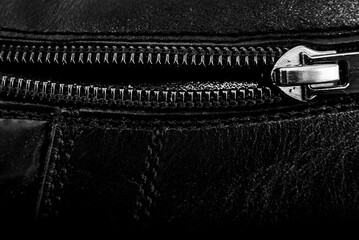 Black lock with a zipper on clothes close-up. Lock.