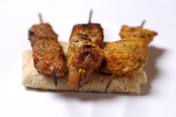 Homemade chicken barbecue on skewers served on crepe