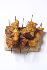 Homemade chicken barbecue on skewers served on crepe