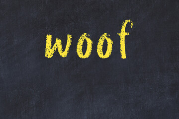 College chalk desk with the word woof written on in