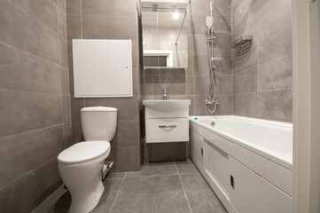 Naklejka na ściany i meble Interior of modern minimalist bathroom with bathtub, toilet, wash basin and shower