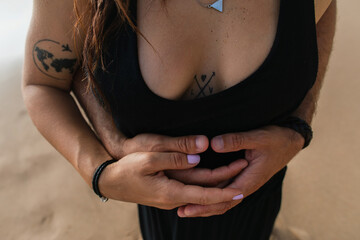 cropped view of man hugging tattooed girlfriend in dress.