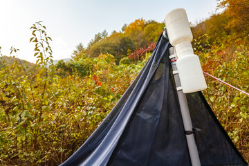 Malaise trap in tall grass, near a forest in Jirisan National Park (Mount Jiri), South Korea. It is a stationary insect trap used by entomologists to inventory insect fauna in a limited area