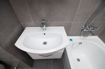 New ceramic sink and bathtub in a bathroom. View from above
