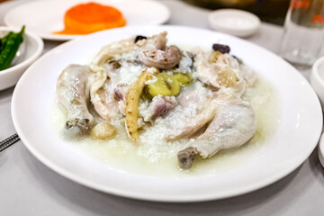 Plate of chicken soup with ginseng and rice, called samgyetang in Korean, close-up view