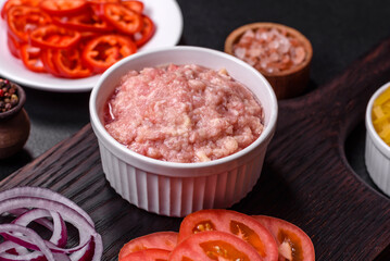 Raw ingredients for delicious Italian pasta: tomatoes, minced meat, pasta, spices and herbs
