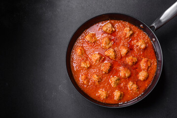 Delicious meatballs made from ground beef in a spicy tomato sauce