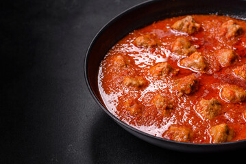 Delicious meatballs made from ground beef in a spicy tomato sauce