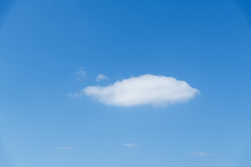 Single white cloud in blue sky