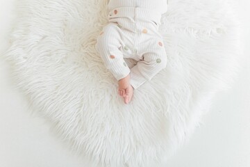 Top view shot of newborn baby's feet on a white carpet