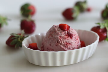 Scoops of Homemade strawberry ice cream. Three ingredient ice cream made of fresh strawberries, whipped cream and condensed milk