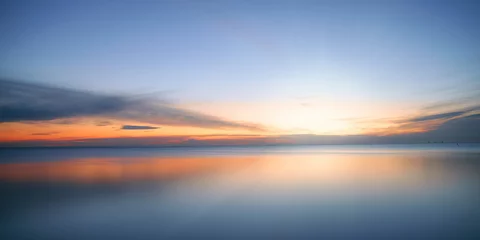 Zelfklevend Fotobehang Calm colored sea and sky at sunset © eshma