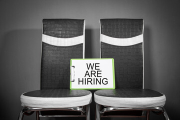 Chairs with a We Are Hiring message. Concept of hiring and recruiting