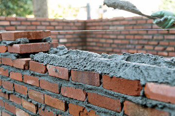 Close up of bricklayer building walls