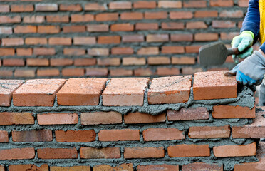 Obraz premium Close up of bricklayer building walls