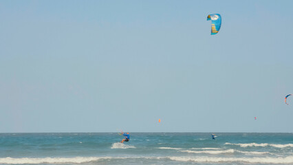Kite surfing or windsurfing on blue sea water